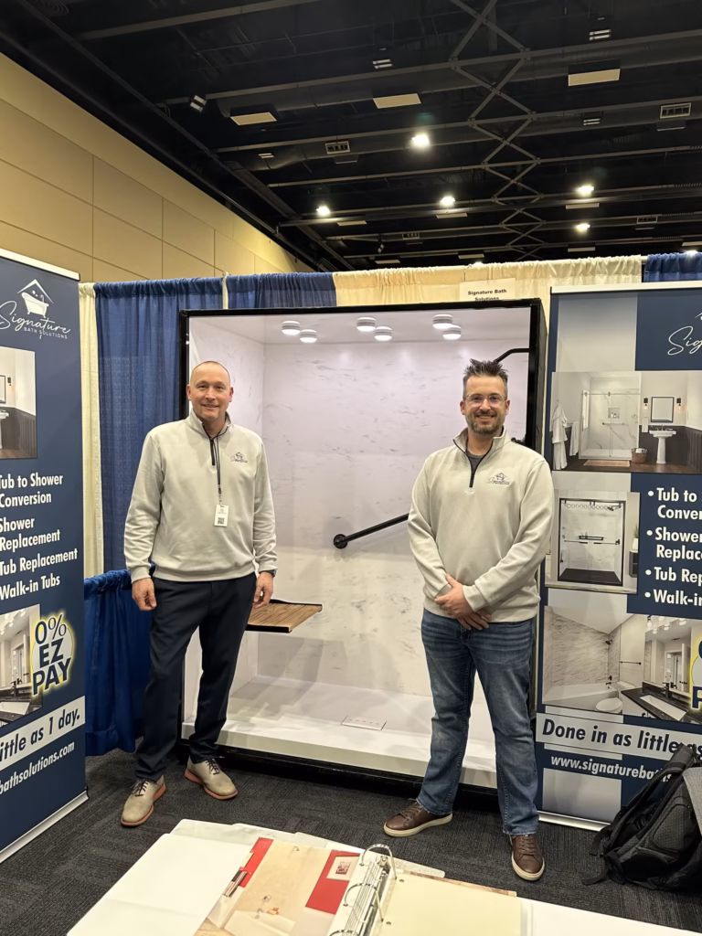 Signature bath solutions owners adam and paul at trade show