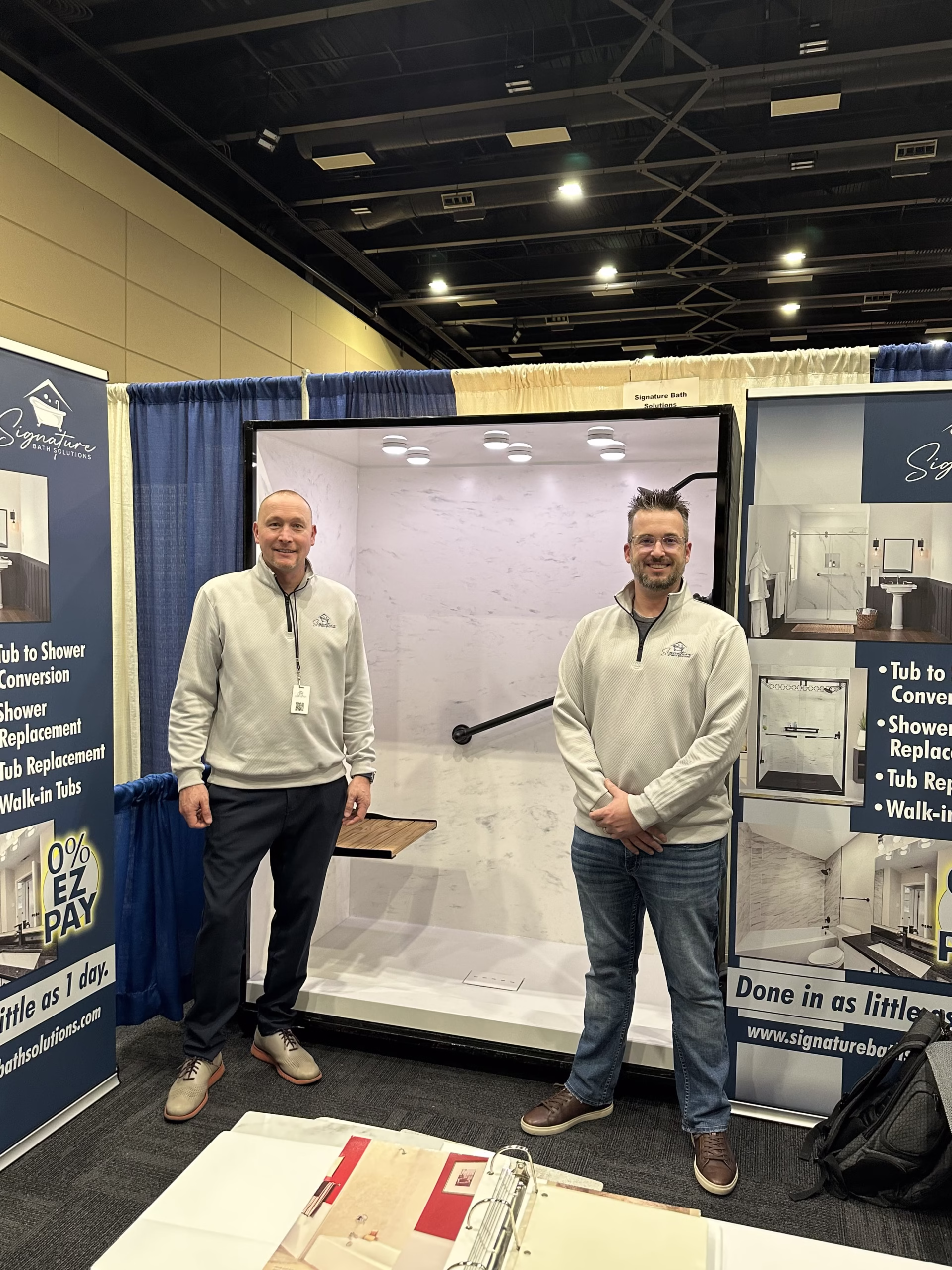 Signature bath solutions owners adam and paul at trade show