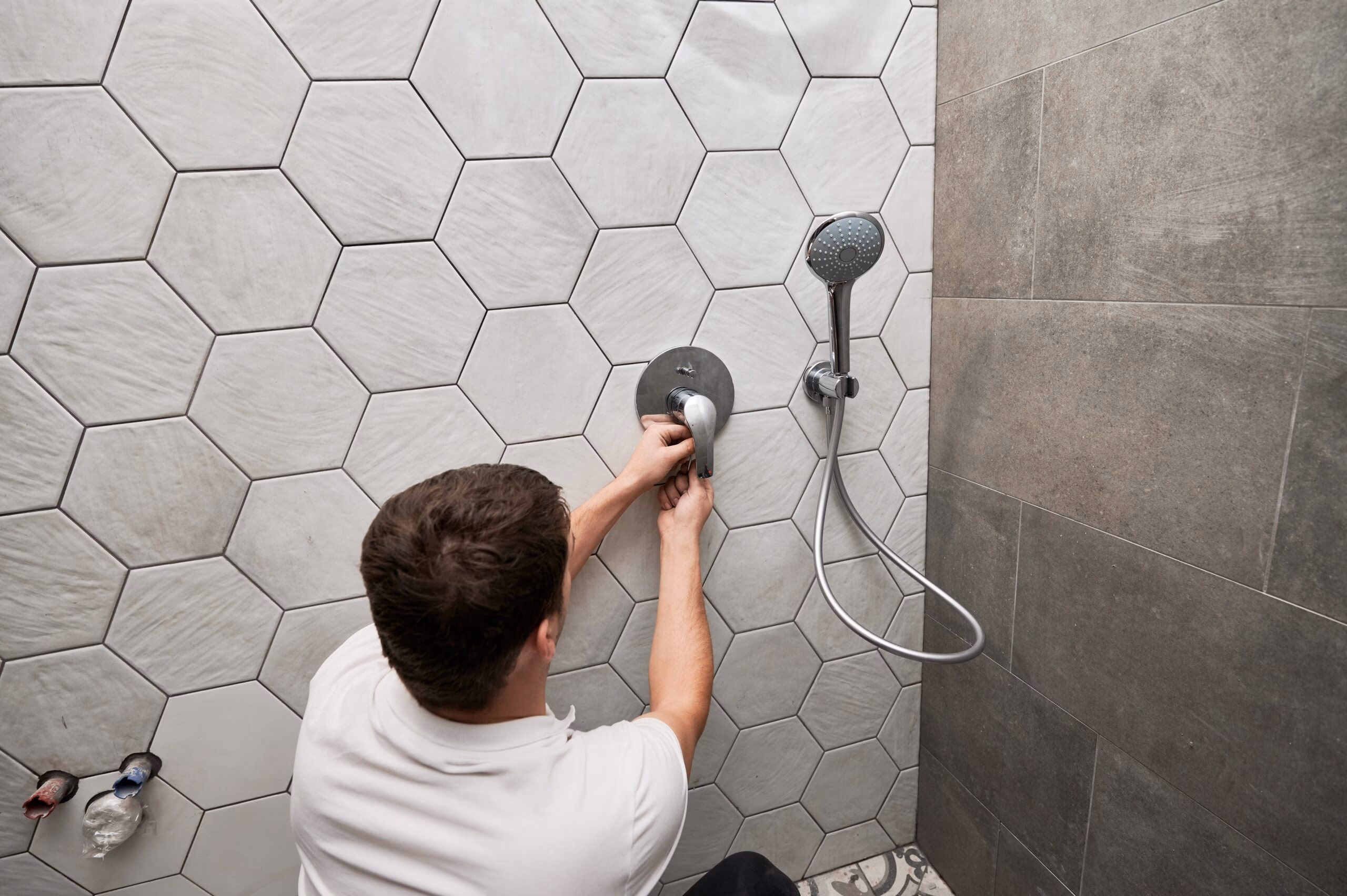 man fixing shower shutterstock stock image hexagon tiles